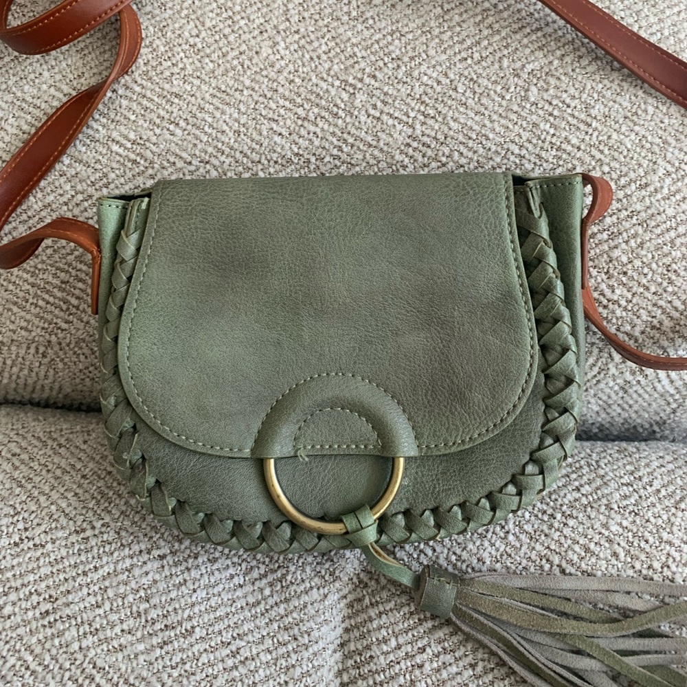 Green purse with tassel and brown leather strap from Anthropologie